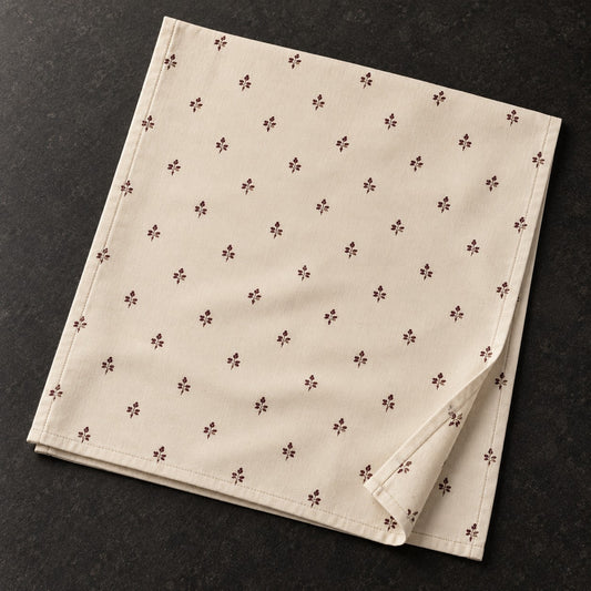 Mulberry & Stone Sprig cotton linen tea towel with small repeating deep mulberry botanical sprigs on a warm ivory ground