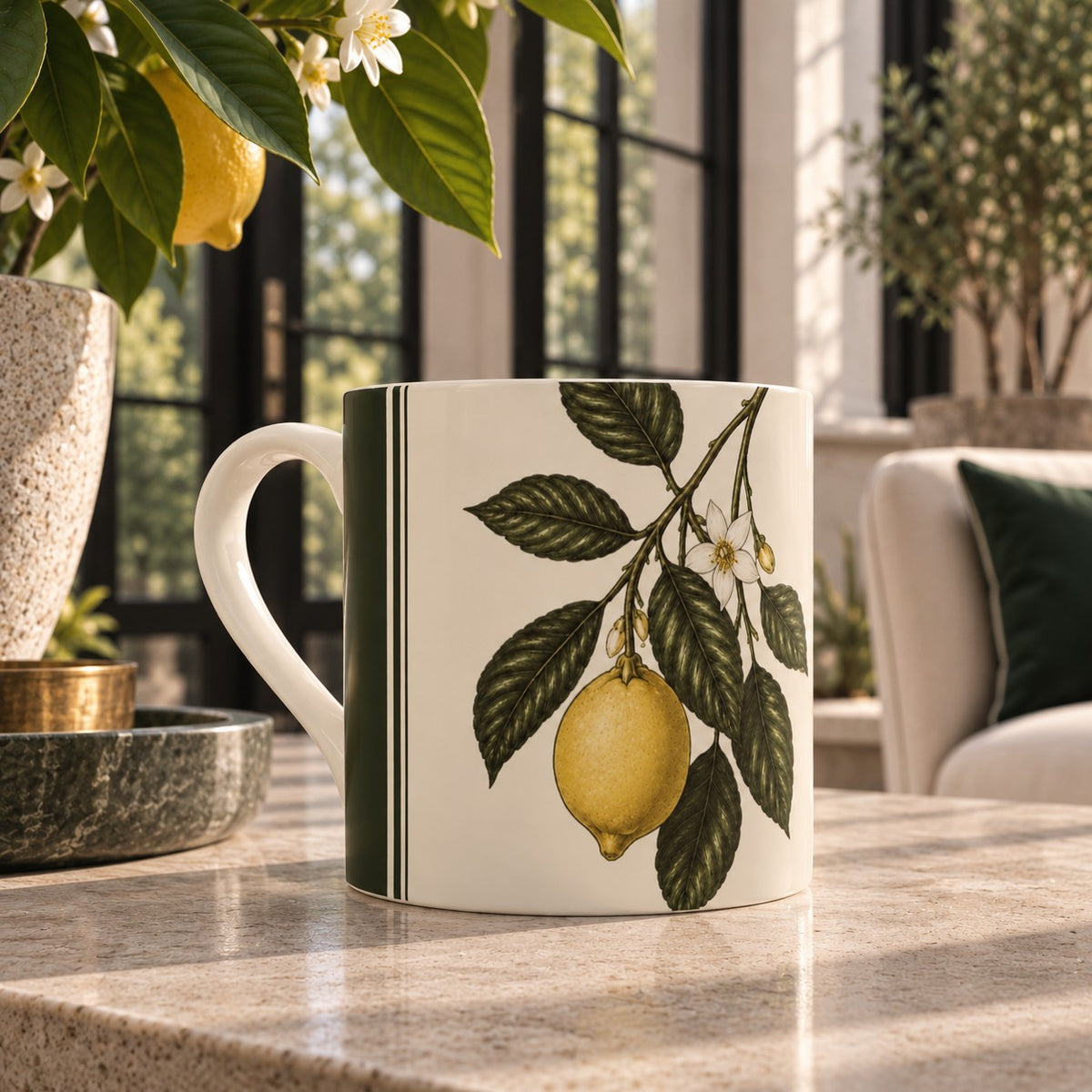 The Orangery Lemon fine bone china mug featuring a ripe yellow lemon, white blossom and deep green foliage with tailored green stripe detailing