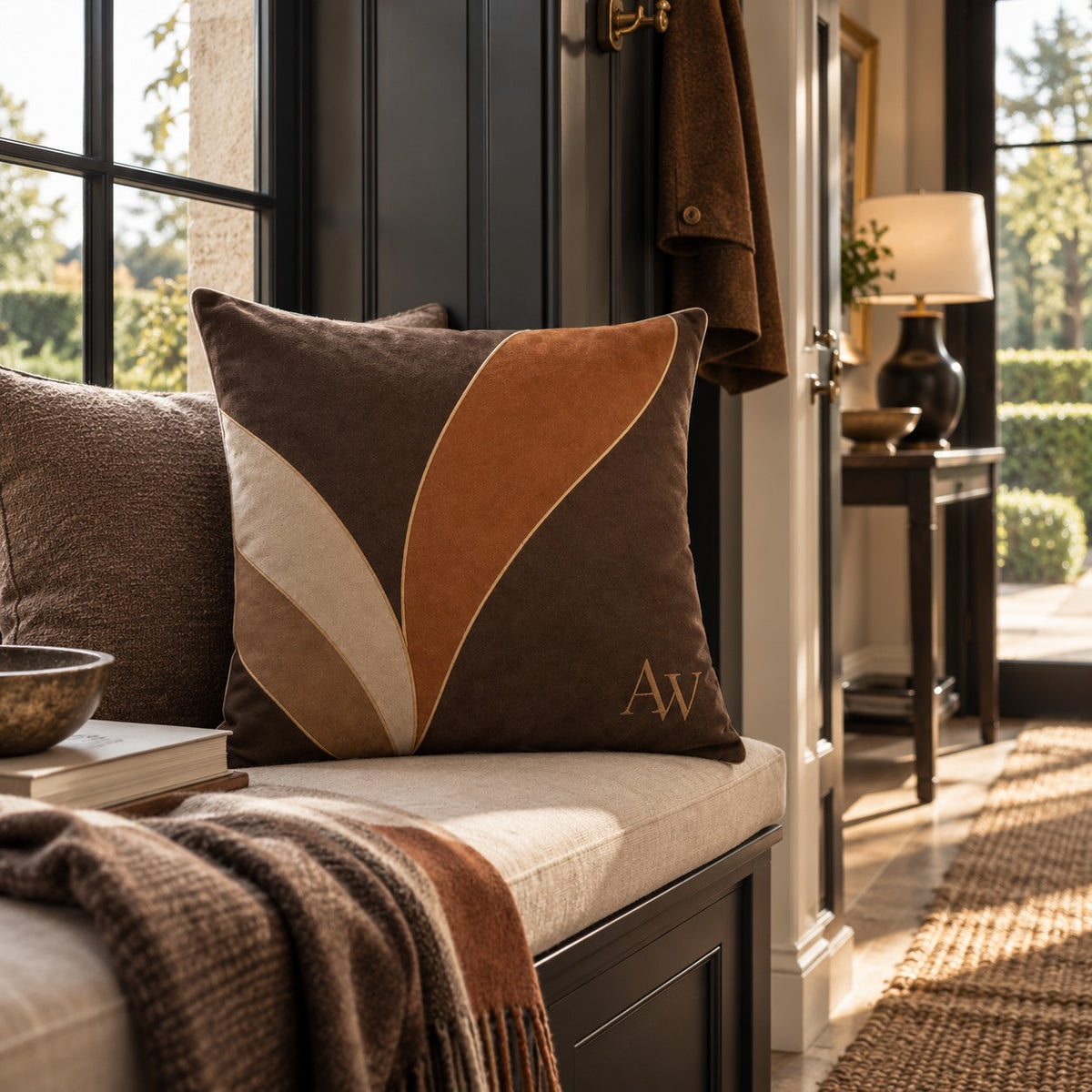 Estate Living Contour 50cm cotton linen cushion with sweeping terracotta, taupe and soft stone forms on deep espresso with fine gold detailing and A&W monogram