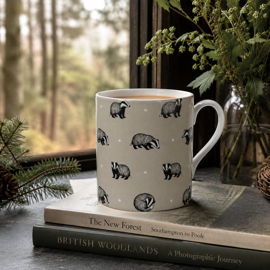 Woodland Badger fine bone china mug featuring illustrated black and white badgers in different poses on a warm taupe ground