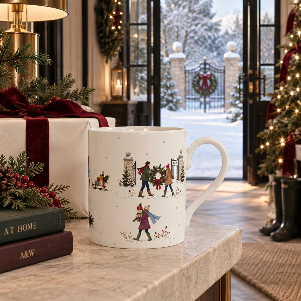 Fine bone china Christmas mug with snowy estate gates, Christmas wreath, presents and people walking home through the snow