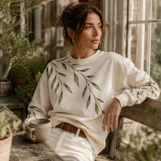 Ivory Willow Branch sweatshirt with sweeping green botanical design across the shoulder and sleeves